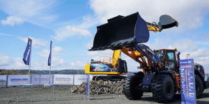 Liugong wheel loaders and construction machinery at a construction trade fair, featuring live demonstrations of machinery for building and construction.