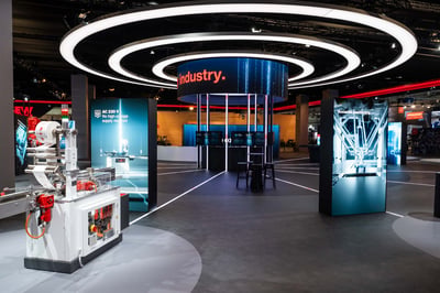 The SEW-EURODRIVE stand features a cockpit-style module at the centre of the stand, as well as LED display stands and recurring design and lighting elements.