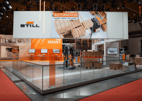 ET GLOBALS's German Design Award 2027 winning exhibition stand for STILL with glass fences, big LED displays and product presentations.