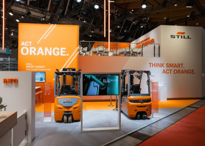 STILL trade show booth at LogiMAT 2026 with a two-story-building and orange design elements.